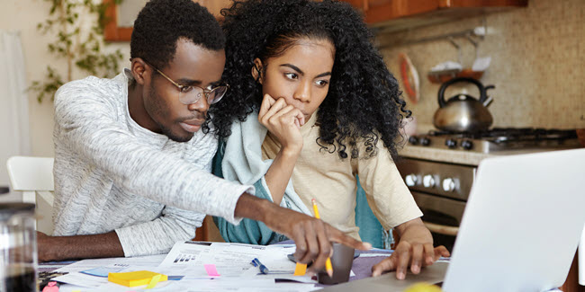 Two U.S. expats filling out IRS Form 8938