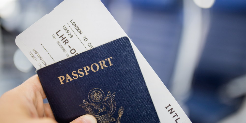 Image of U.S. passport and a U.S. expat's plane ticket
