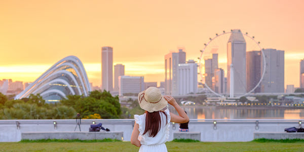 american female with hat who pays U.S. expat taxes in singapore